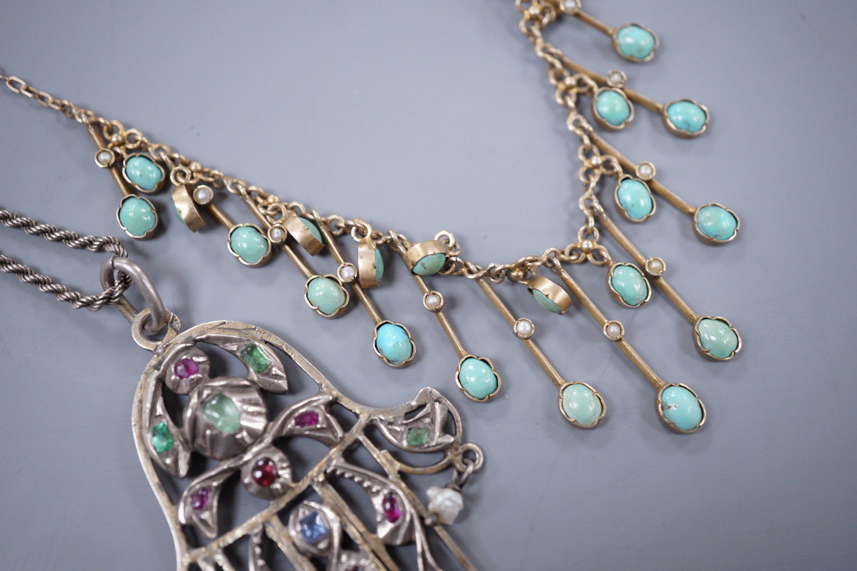 A Continental gem set white metal Hand of Fatima pendant, and a base metal turquoise set fringe necklace